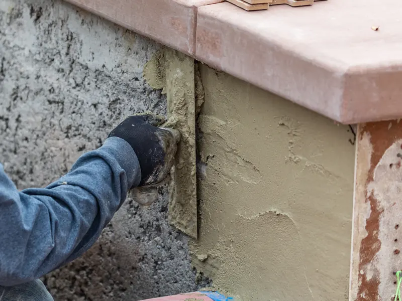Stucco going on over block, the kind of wall work priced in a written estimate